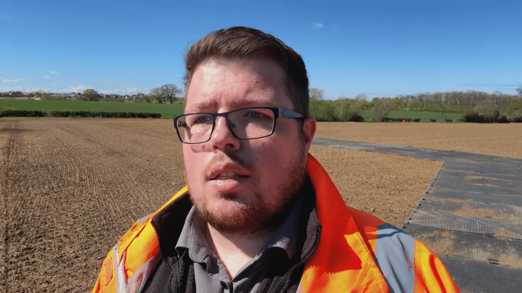 Lawrence filming HDPE plastic trackway installation